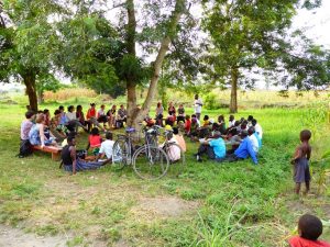 a group of people listening to a presentation