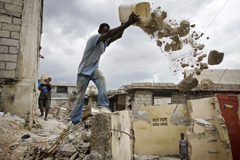man emptying rubble from a bucket