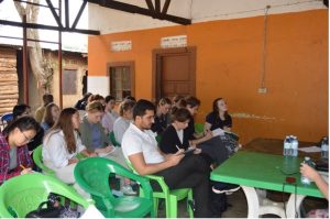HCRI students in chairs taking notes